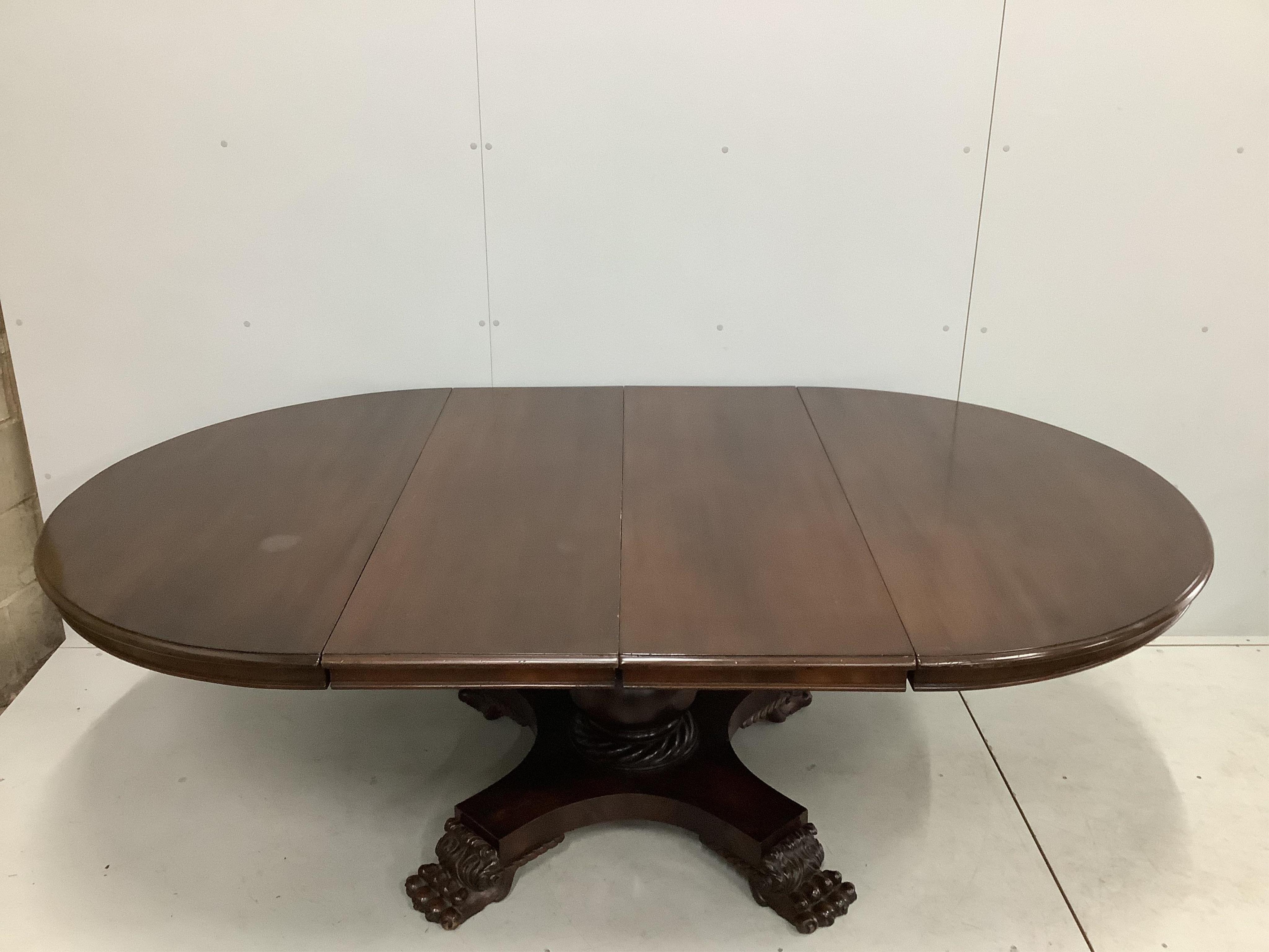 A George IV style circular mahogany extending dining table, 224cm extended, two spare leaves, width 134cm, height 74cm. Condition - fair to good